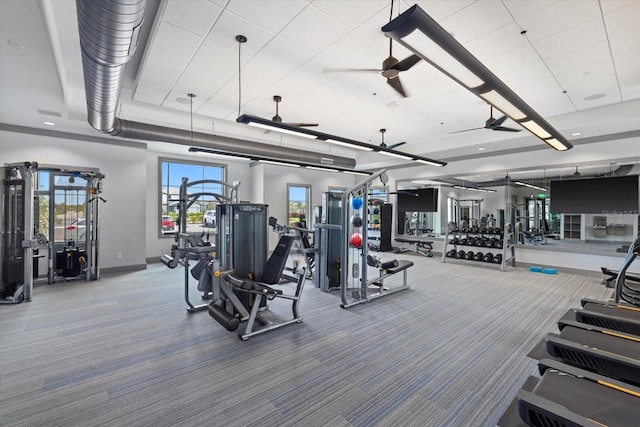 exercise room featuring ceiling fan and carpet flooring