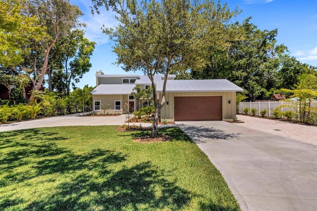 view of front of house featuring a garage and a front lawn