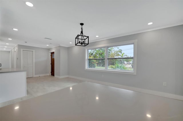 unfurnished dining area with an inviting chandelier and crown molding