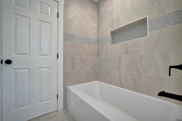 bathroom with tile patterned floors and tiled shower / bath combo