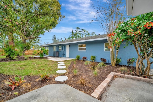 single story home with a patio area and a front lawn