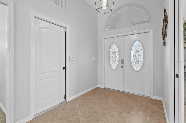 foyer entrance with light tile patterned floors