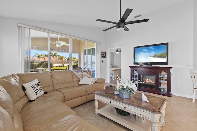 living room with vaulted ceiling, light tile patterned floors, and ceiling fan