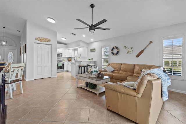 tiled living room featuring sink and ceiling fan