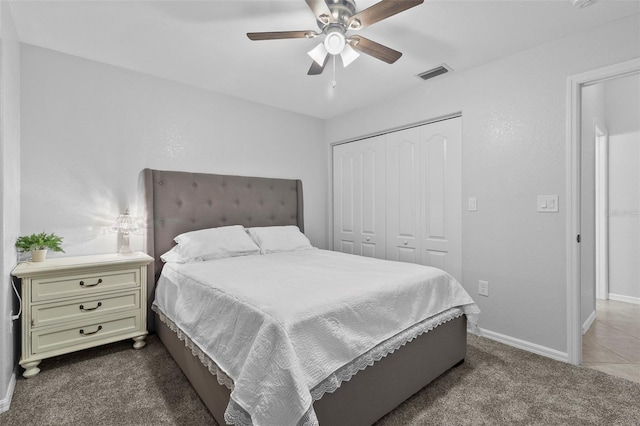 bedroom with a closet, ceiling fan, and dark colored carpet