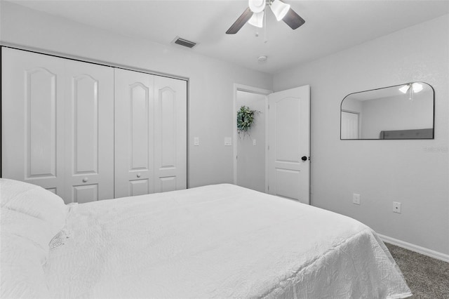 carpeted bedroom with ceiling fan and a closet