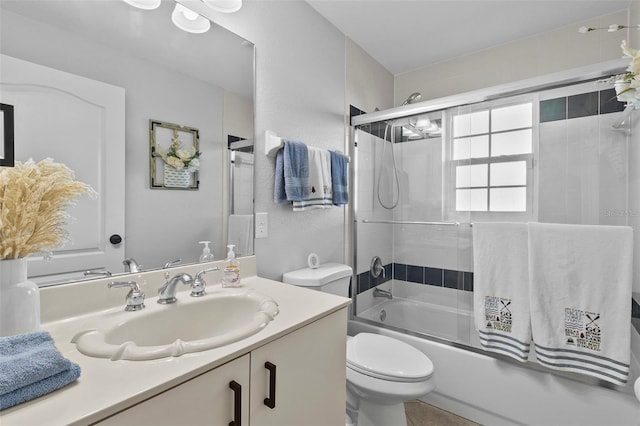 full bathroom featuring bath / shower combo with glass door, vanity, and toilet