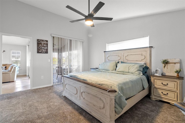 carpeted bedroom featuring access to exterior, vaulted ceiling, and ceiling fan