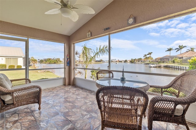 sunroom / solarium featuring a water view, ceiling fan, and lofted ceiling