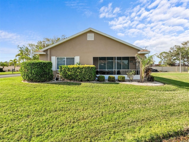 rear view of house featuring a yard