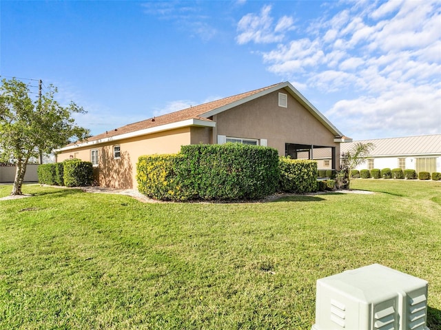 view of side of home with a lawn