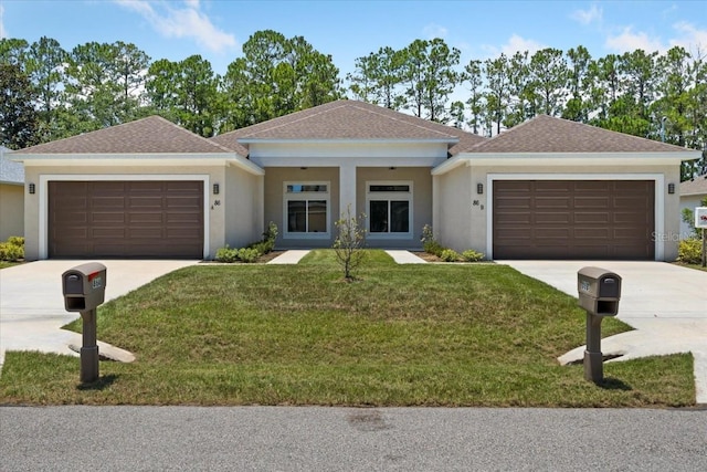 view of front facade with a garage and a front lawn