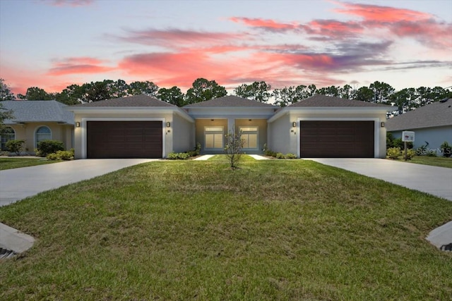 view of front of house featuring a garage and a yard