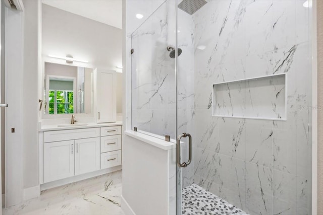 bathroom with vanity and a shower with door