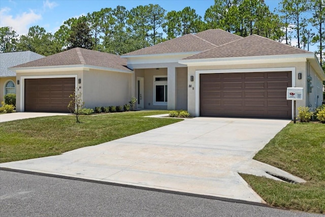 view of front facade with a front yard and a garage