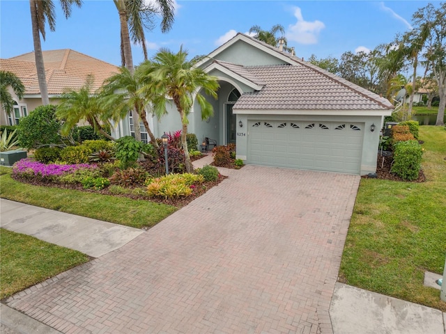 view of front of house featuring a front lawn and a garage