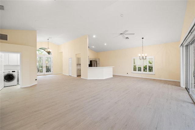 unfurnished living room featuring light wood finished floors, plenty of natural light, french doors, and washer / clothes dryer