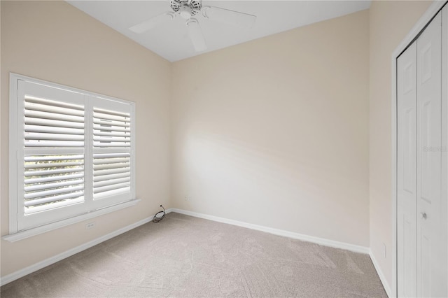 unfurnished bedroom featuring a closet, light carpet, and baseboards