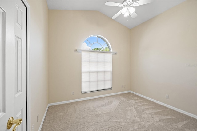 spare room featuring carpet flooring, baseboards, a ceiling fan, and vaulted ceiling