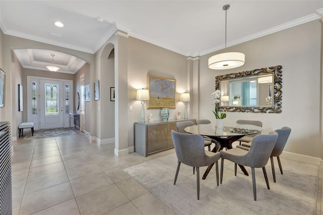 tiled dining area featuring crown molding