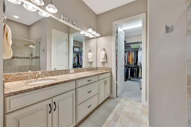 bathroom featuring tile patterned floors, vanity, and an enclosed shower