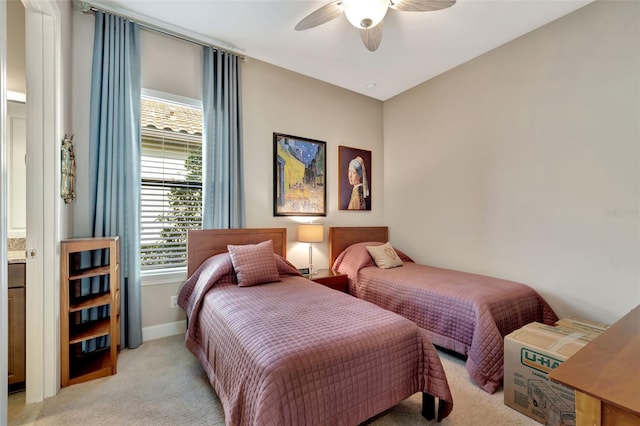 carpeted bedroom featuring ensuite bath and ceiling fan