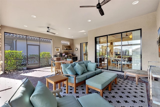 living room featuring a healthy amount of sunlight and ceiling fan