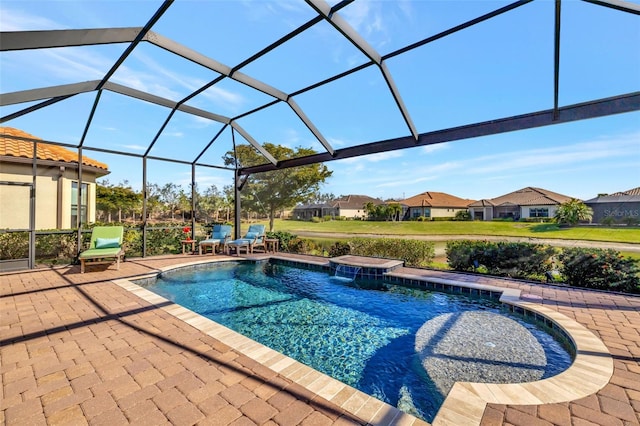 view of swimming pool featuring a hot tub, a patio, pool water feature, and glass enclosure