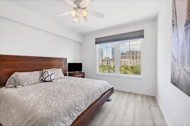 bedroom with ceiling fan and light hardwood / wood-style floors