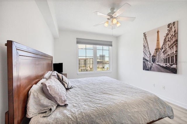 bedroom with ceiling fan and wood-type flooring