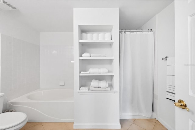 bathroom with toilet and tile patterned flooring