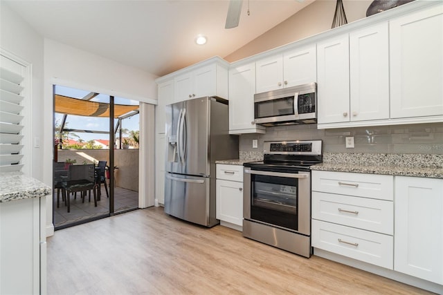 kitchen featuring white cabinets, appliances with stainless steel finishes, and decorative backsplash