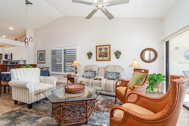 living room featuring lofted ceiling, ceiling fan, and light hardwood / wood-style floors