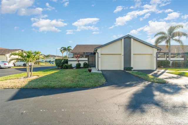 ranch-style home featuring a garage and a front lawn