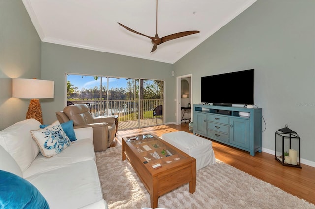 living room with light hardwood / wood-style floors, ceiling fan, and vaulted ceiling