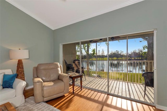 interior space with vaulted ceiling, crown molding, wood-type flooring, and a water view