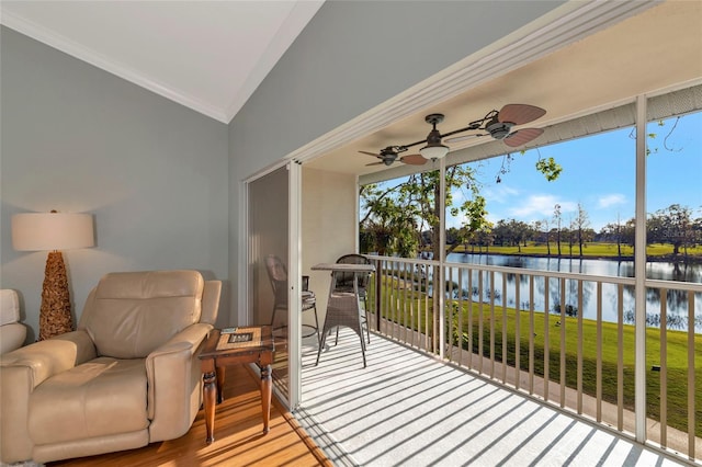 sunroom featuring ceiling fan, a water view, and vaulted ceiling