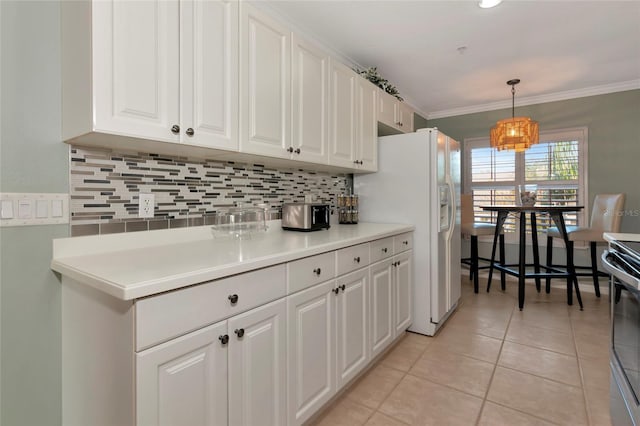 kitchen with decorative light fixtures, light tile patterned floors, white refrigerator with ice dispenser, and white cabinetry