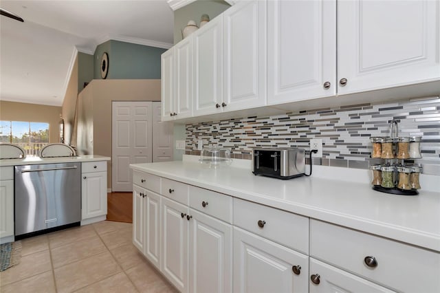 kitchen with light tile patterned floors, white cabinets, dishwasher, and crown molding