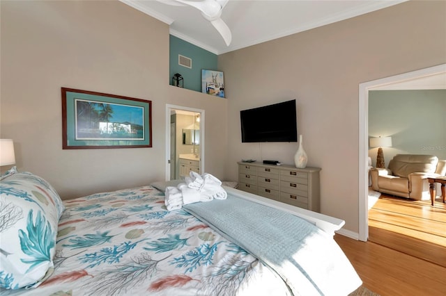 bedroom featuring ceiling fan, ornamental molding, hardwood / wood-style floors, and ensuite bathroom