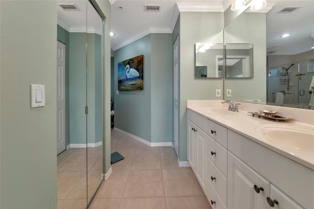 bathroom featuring a shower with shower door, ornamental molding, tile patterned floors, and vanity