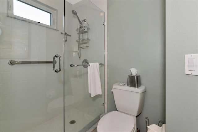 bathroom with toilet and walk in shower