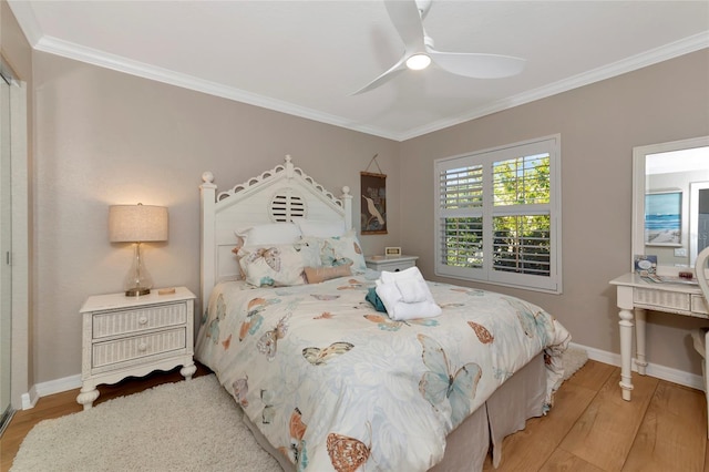 bedroom featuring ornamental molding, ceiling fan, and light hardwood / wood-style floors