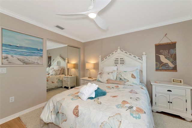 bedroom featuring ornamental molding, a closet, ceiling fan, and light wood-type flooring