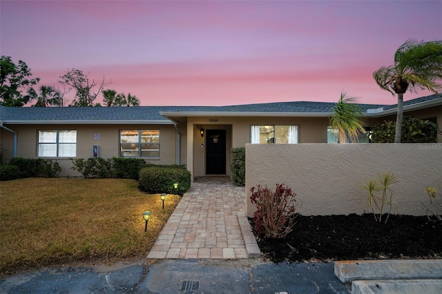 view of front of home with a yard