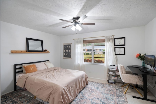 bedroom with a textured ceiling and ceiling fan