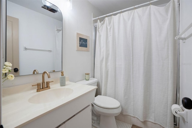 bathroom featuring tile patterned floors, vanity, and toilet