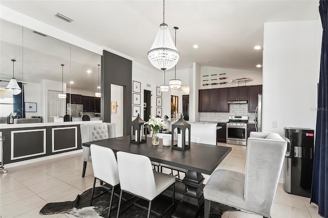 tiled dining area featuring a chandelier