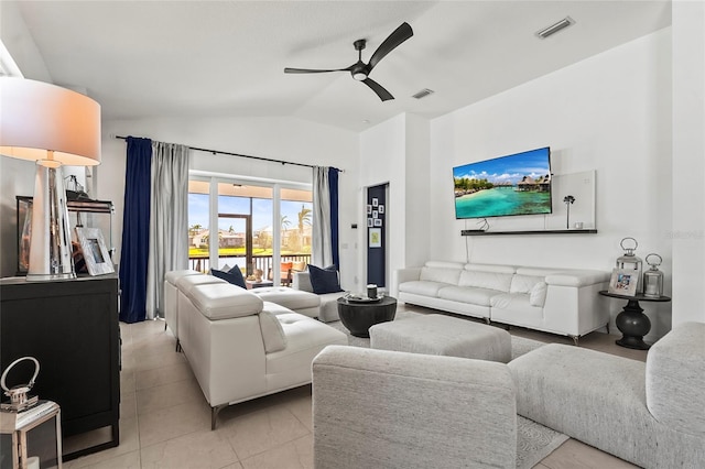 living room with vaulted ceiling, light tile patterned floors, and ceiling fan