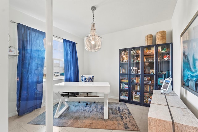 home office featuring light tile patterned floors and a chandelier